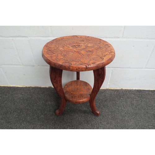 1048 - A Chinese carved wood two-tier lamp table with dragon design, 49cm tall x 36cm diameter