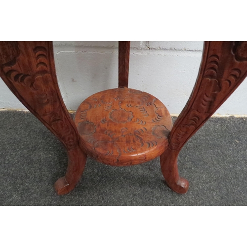 1048 - A Chinese carved wood two-tier lamp table with dragon design, 49cm tall x 36cm diameter