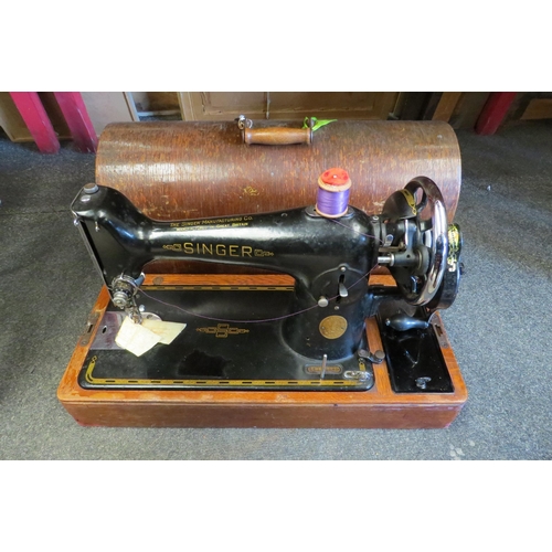 1058 - An oak cased Singer sewing machine