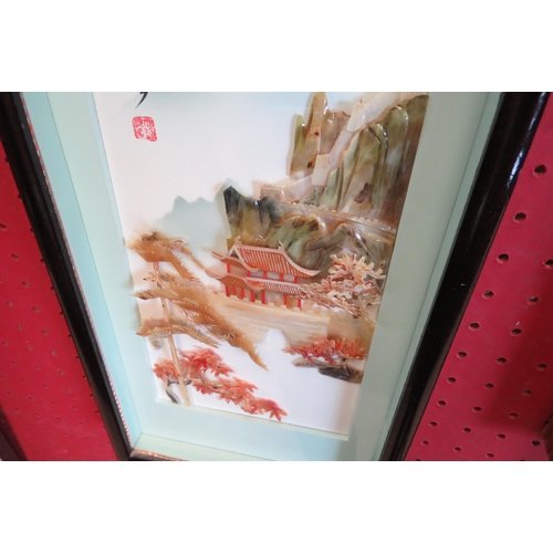 1068 - A shell relief picture of a Japanese pagoda scene.  Framed and glazed.  26cm x 12cm image size