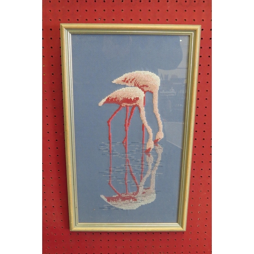 1069 - NANCY DAD: A needlepoint of pink flamingos, framed and glazed, 44.5cm x 24.5cm image size