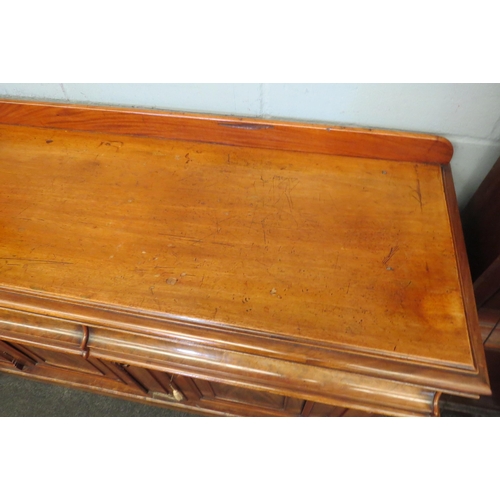 1087 - A Victorian mahogany sideboard, two cushion drawers over two cupboard door bases, loss to moulding, ... 