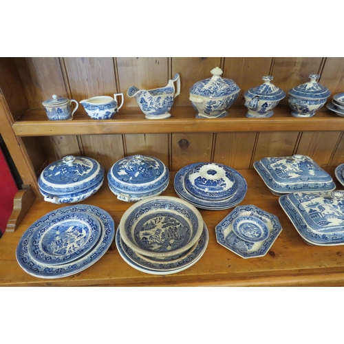 1090 - A collection of Willow pattern blue and white ceramics including Wedgwood and Ridgways jugs, dishes,... 