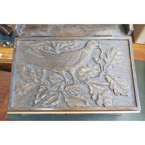 1098 - An early 20th Century carved oak writing slope, design of bird in an oak tree, repair to front, larg... 