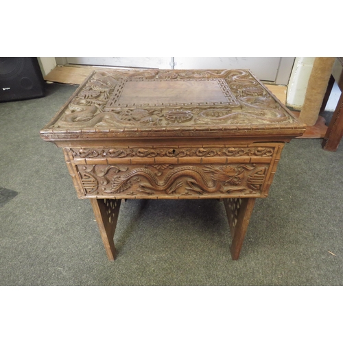 1099 - A Chinese carved hardwood rectangular topped occasional table, decorated with relief of dragons and ... 