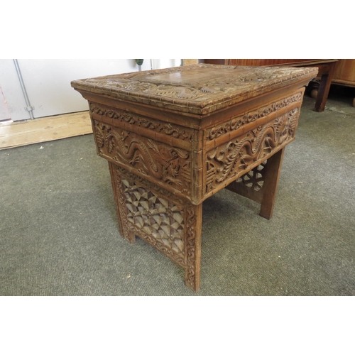 1099 - A Chinese carved hardwood rectangular topped occasional table, decorated with relief of dragons and ... 