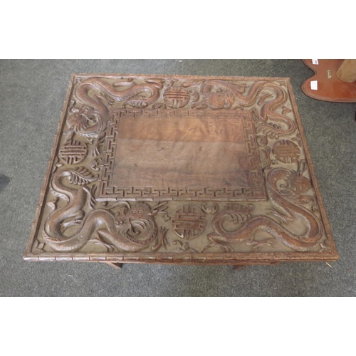 1099 - A Chinese carved hardwood rectangular topped occasional table, decorated with relief of dragons and ... 