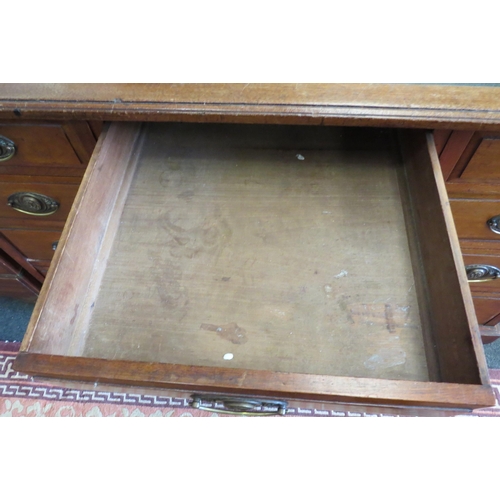 1100 - A circa 1900 walnut twin pedestal desk, nine drawer front set with brass handles, on plinth base, 76... 