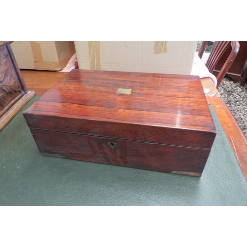 1105 - A Victorian rosewood writing box with cartouche to lid and purple velvet interior