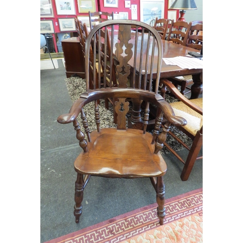 1117 - A reproduction of an 18th Century hoop-back Windsor armchair, pierced fiddle splat back, shaped seat... 