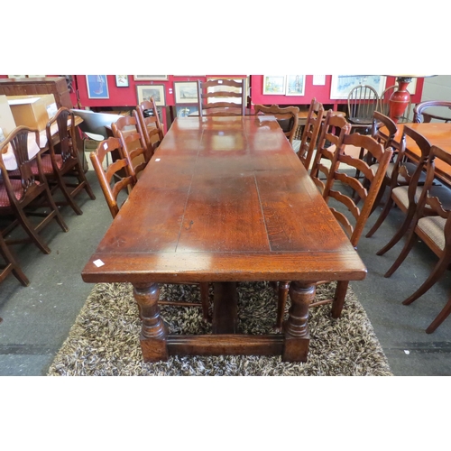 1120 - A reproduction country oak refectory dining table in the Jacobean style, plank top over heavy turned... 