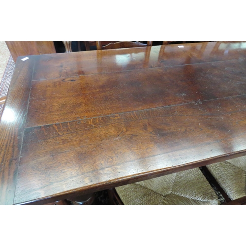 1120 - A reproduction country oak refectory dining table in the Jacobean style, plank top over heavy turned... 