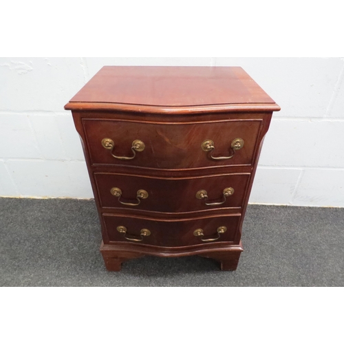 1121 - A 20th Century serpentine bedside chest of three drawers, 65cm tall x 50cm wide x 36cm deep