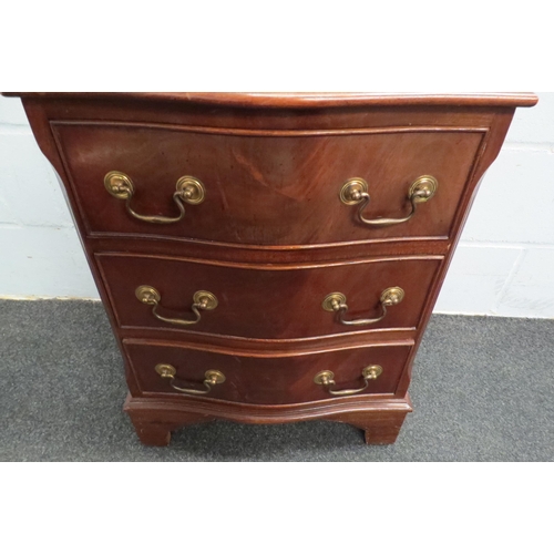 1121 - A 20th Century serpentine bedside chest of three drawers, 65cm tall x 50cm wide x 36cm deep