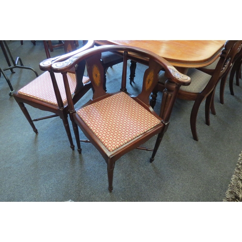 1125 - A pair of inlaid mahogany corner chairs on turned leg supports united by a turned 