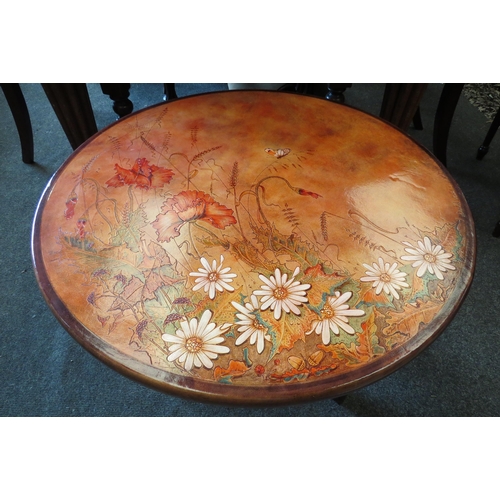 1127 - A leather embossed coffee table marked David 2001 to top, 44cm tall x 60cm diameter