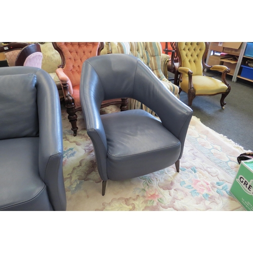 1159 - A blue leather three piece designer suite comprising of two seater sofa and a pair of matching chair... 