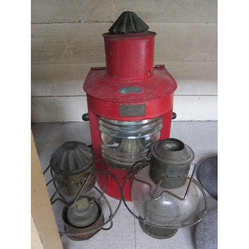 8120 - A red painted metal Stern ship’s lamp by Valmet, together with two globular lamps a/f