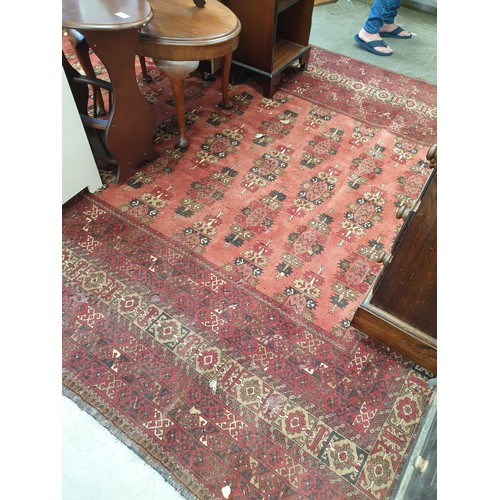 2441 - A floral woven brown and red rug, a/f, 310cm x 221cm a/f