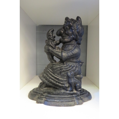 1252 - A cast iron Judy and baby doorstop, 28cm tall