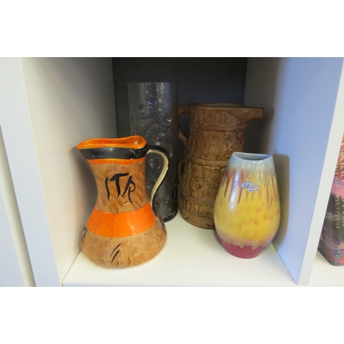 1256 - A Topeko drip glaze studio pottery vase together with a cylindrical glass vase 28cm tall and two jug... 