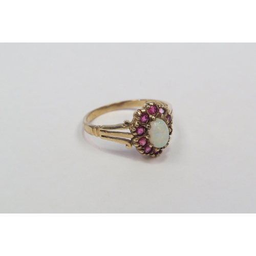 1303 - A 9ct gold opal and ruby set ring.  Approximately 2g