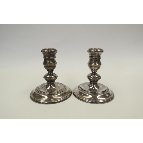 1311 - A pair of William Comyns & Sons silver candlesticks.  Height approximately 11cm