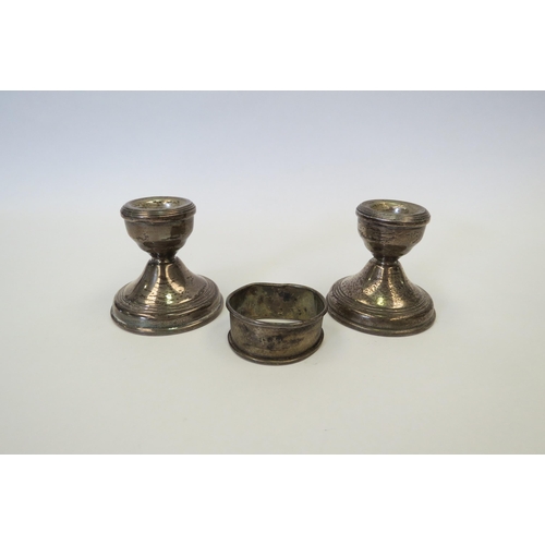 1319 - Two silver squat candle sticks and a napkin ring