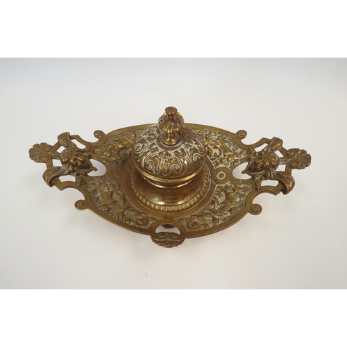 1331 - A Victorian decorative brass inkwell with glass liner