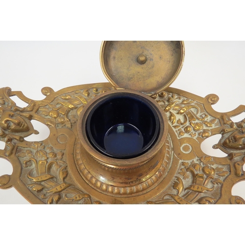 1331 - A Victorian decorative brass inkwell with glass liner