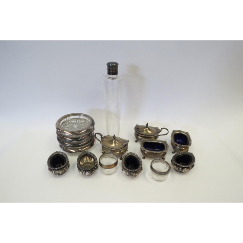 1332 - A selection of silver and blue glass insert condiment pots together with silver plated bottle coaste... 