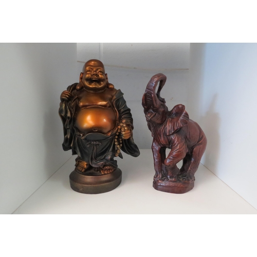 1348 - A figure of a Jolly Buddha, 22cm tall, and a model of an elephant