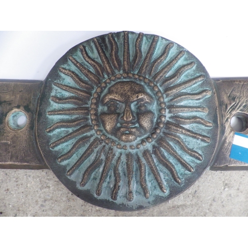 1077 - Two bronze plaques, with sun-face detail, marked J1998M