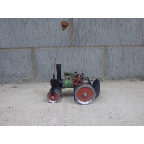 1080 - A Mamod live-steam model steam road roller, with burner tray. Well played with. Marked Mamod to pist... 