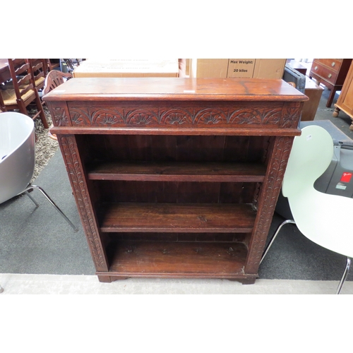 1113 - A carved oak bookcase, lunette frieze, on bracket feet, 105cm tall x 90cm wide x 25cm deep          ... 