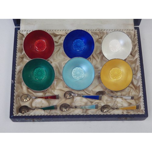 1086 - A set of six mid-20th Century Danish table salts and spoons, enamelled in harlequin colours. Stamped... 