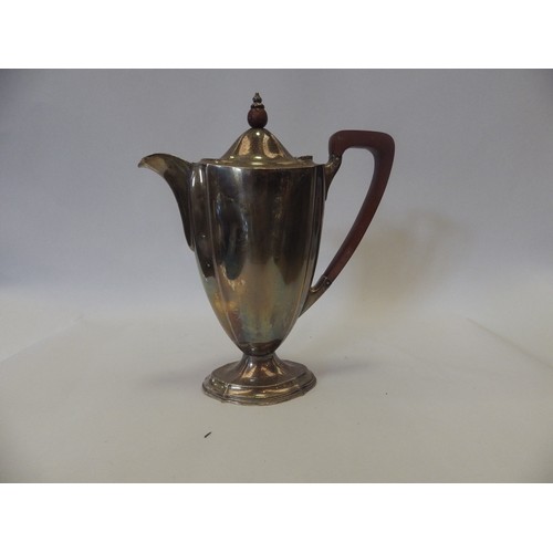 1089 - A George V silver coffee pot of flared shaped oval form on a shaped oval foot, with stained wooden h... 