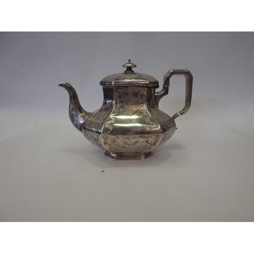 1091 - A Victorian silver teapot of panelled baluster form, chased with strapwork. London 1841. Retailed by... 