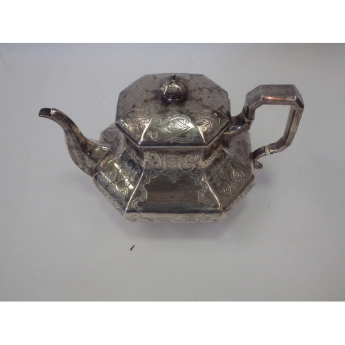 1091 - A Victorian silver teapot of panelled baluster form, chased with strapwork. London 1841. Retailed by... 