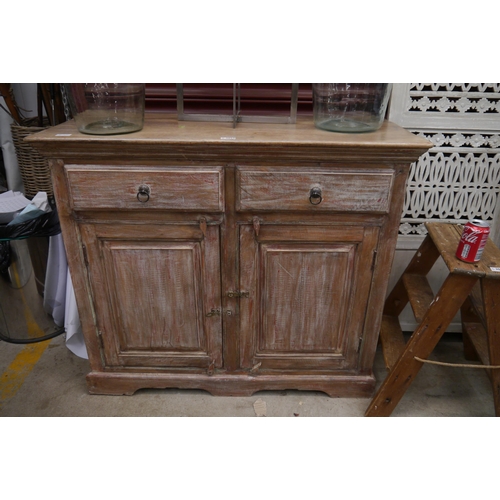 2059 - A rustic limed oak sideboard, two doors over two door cupboard