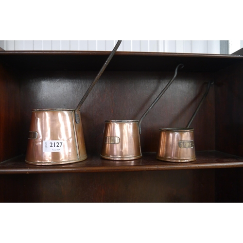 2127 - A set of three graduated copper cider measures