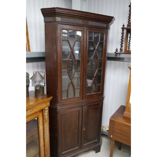 2148 - A George III oak two door glazed corner cabinet on a two door base and bracket feet (with key)   (R)... 