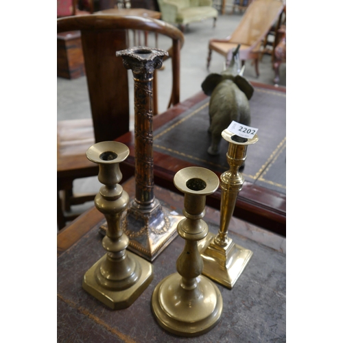 2202 - Four various copper and brass candlesticks