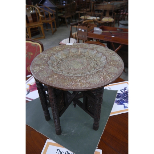 2228 - A 1920's Anglo Indian brass top occasional table with peacock design