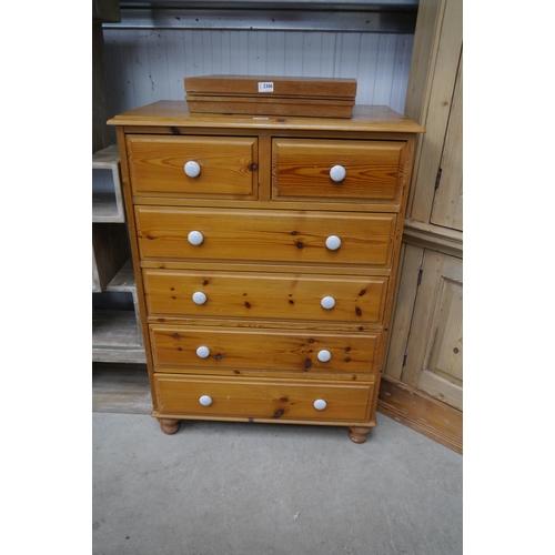 2305 - A pine two over four chest of drawers with porcelain knobs