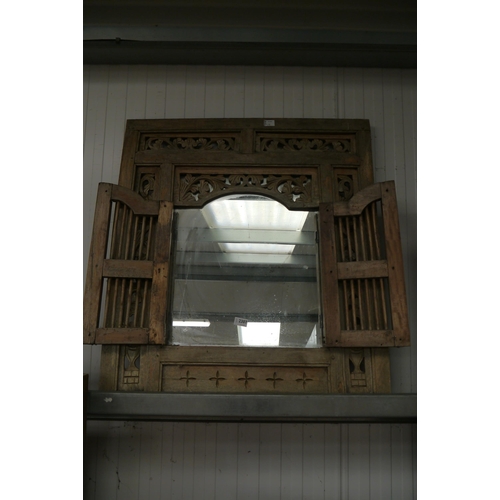 2307 - An Indian carved wood wall feature, twin doors opening to reveal mirror