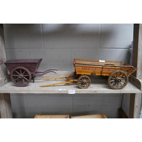 2310 - A wooden model four wheel hay cart and a two wheel cart