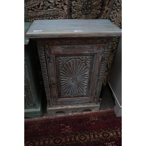 2448 - An Indian rustic painted cabinet, single carved door with wavy plinth base