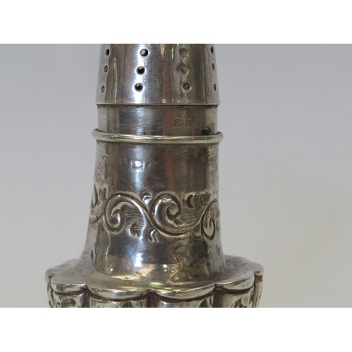 1087 - A pair of Edwardian silver pepperettes of pedestal baluster form, with repousse decoration. Birmingh... 