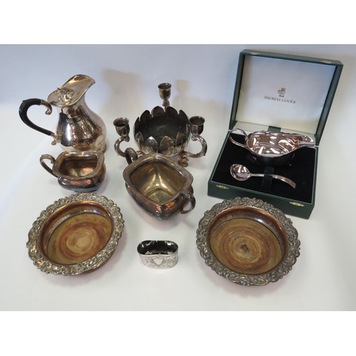 1088 - Mixed silver-plated service ware, including two wood-lined decanter stands, a three sconce table-cen... 